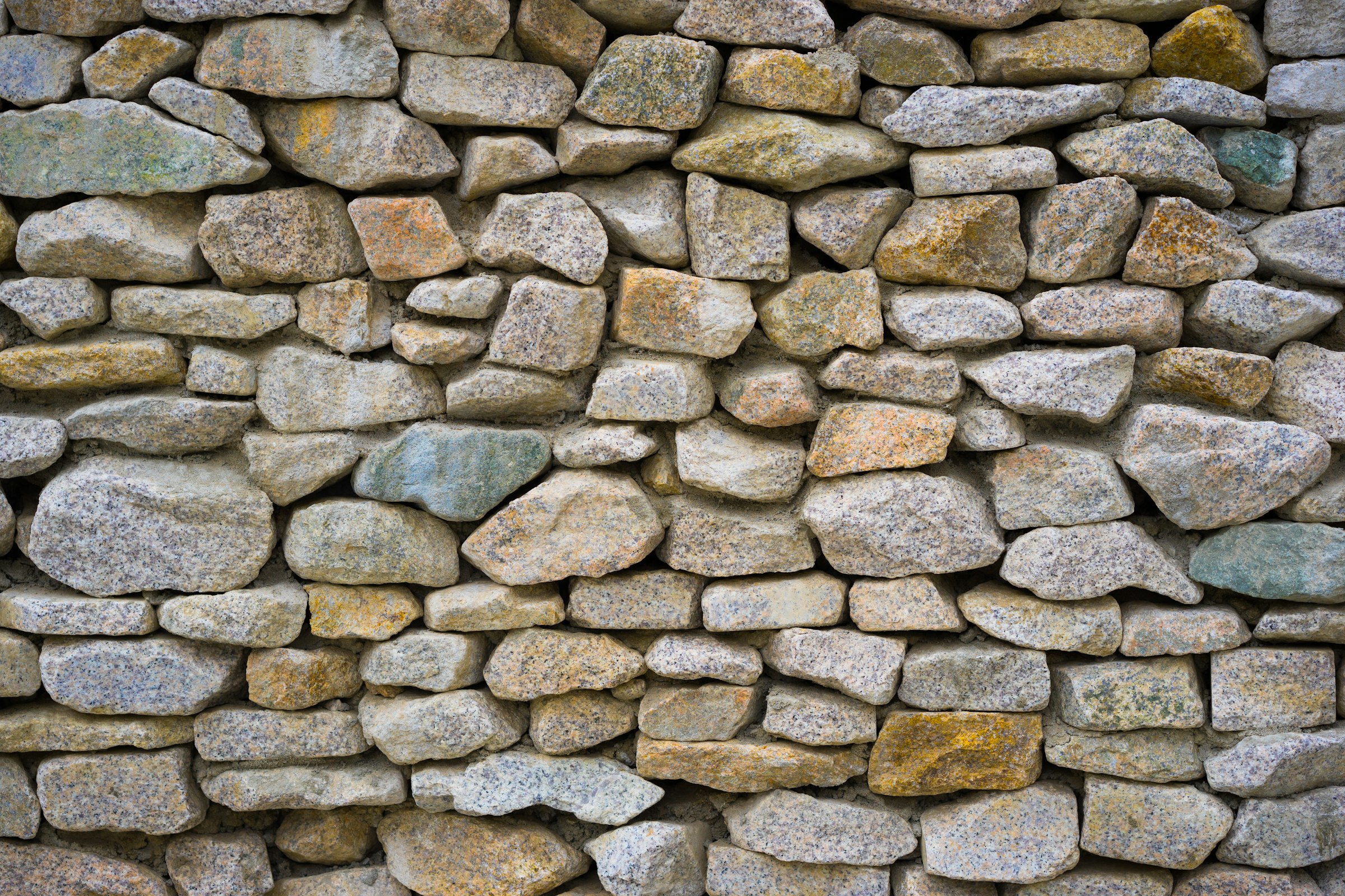 Rustic wall of fitted natural fieldstone in warm tones